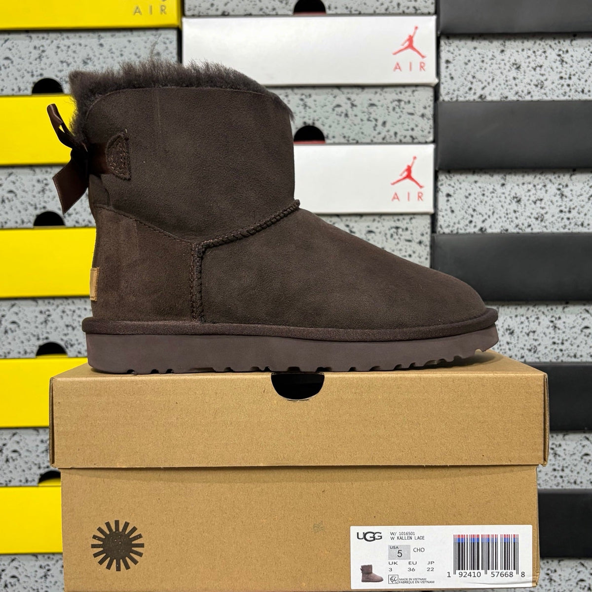 UGG Mini Bailey Bow Ankle Boot – Suede Boot with Tonal Dark Shearling Lining, Chocolate Satin Bow & Dark Sugar Sole in Chocolate