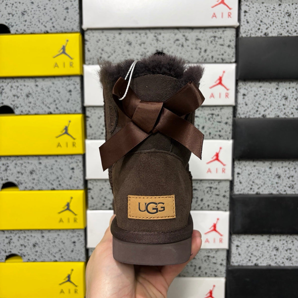 UGG Mini Bailey Bow Ankle Boot – Suede Boot with Tonal Dark Shearling Lining, Chocolate Satin Bow & Dark Sugar Sole in Chocolate